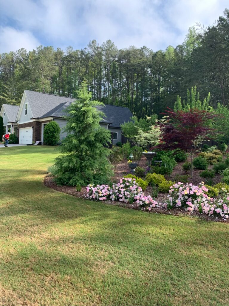 landscape-tech-with-leaf-blower A landscape tech uses a leaf blower on a freshly mowed lawn.